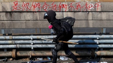 A protester walks at the occupied campus of the Chinese University in Hong Kong, China, November 13, 2019. REUTERS/Thomas Peter - RC27AD95HF3J HONGKONG-PROTESTS/