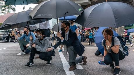 HONG KONG, CHINA - NOVEMBER 13: Pro-democracy protesters hold umbrellas as during a standoff with police on November 13, 2019 in Hong Kong, China. Anti-government protesters organized a general strike since Monday as demonstrations in Hong Kong stretched into its sixth month with demands for an independent inquiry into police brutality, the retraction of the word "riot" to describe the rallies, and genuine universal suffrage. (Photo by Anthony Kwan/Getty Images) 1182157558