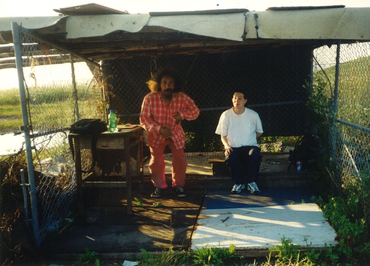 An old photo of two people is shown