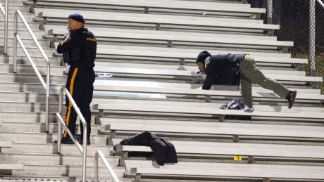 Pleasantville police search the stands after a shooting during a football game at Pleasantville High School in Pleasantville, N.J., Friday, Nov. 15, 2019. Players and spectators ran for cover Friday night when a gunman opened fire at the New Jersey high school football game. (Edward Lea/The Press of Atlantic City via AP) High School Game Shooting