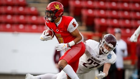 Calgary's Jalen Philpot eludes McMaster's Eric Blake in the Dinos' win on Saturday in the Mitchell Bowl. Philpot and his twin brother, Tyson, are sons of former CFLer Cory Philpot. FBO Mitchell Bowl 20191116