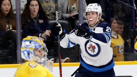 Winnipeg's Patrik Laine celebrates after scoring a first-minute goal against Nashville goaltender Juuse Saros during the Jets' 2-1 win over the Predators on Tuesday. laine-patrik-111919