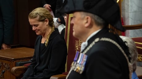 Usher of the Black Rod Greg Peters looks on as Governor General Julie Payette sits in the Senate Chamber. Royal Ascent 20190621