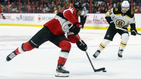 Ottawa forward Anthony Duclair takes a shot on net as Boston's Jake DeBrusk looks on during the second period of the Senators' 5-2 win against the Bruins on Monday. duclair-anthony-120919