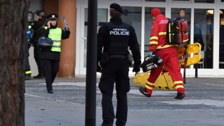 Police personnel and paramedics outside the Ostrava Teaching Hospital after a shooting incident in Ostava, Czech Republic, Tuesday, Dec. 10, 2019. Police and officials say at least four people have been killed in a shooting in a hospital in the eastern Czech Republic. Two others are seriously injured. (Jaroslav Ozana/CTK via AP) Czech Hospital Shooting