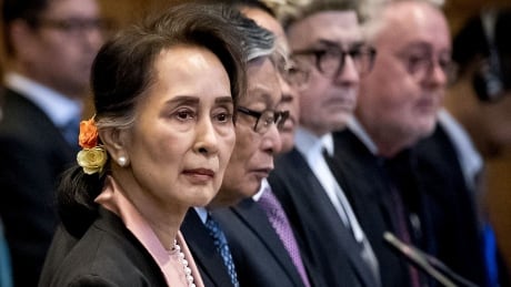 Myanmar's State Counsellor Aung San Suu Kyi stands before UN's International Court of Justice on December 10, 2019 in in the Peace Palace of The Hague, at the start of a three-day hearing on Rohingya genocide case. - The case, brought by the west African state of Gambia, is the first attempt to bring Myanmar to justice over its bloody 2017 military crackdown on the Rohingya Muslim minority. 1187466986