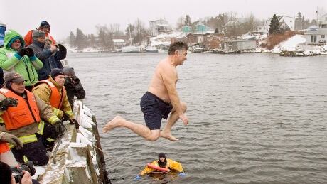 An unidentified man braves the elements as he jumps from the government wharf into the icy waters of the North Atlantic in Herring Cove, N.S. on Thursday, Jan. 1, 2009. The community was celebrating their 15th annual polar bear swim to welcome the new year. 2224819