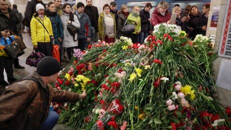 People gather at a symbolic memorial at Technologicheskiy Institute subway station in St.Petersburg, Russia, Friday, April 7, 2017. A bomb blast tore through a subway train under Russia's second-largest city on Monday, killing people and wounding more than 40. Russia Subway Explosion
