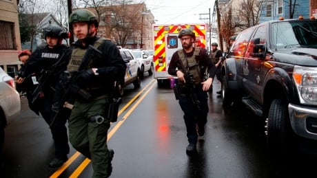 Law enforcement arrives at the scene where multiple people were killed by gunfire, in Jersey City, N.J., on Tuesday, Dec. 10, 2019. Shooting Jersey City