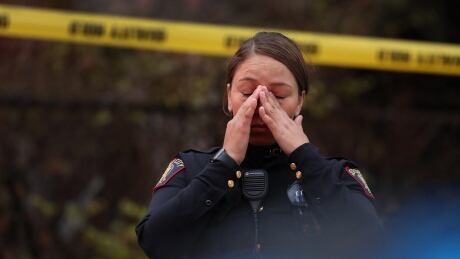 A Jersey City police officer reacts at the scene of a shooting that left multiple people dead on Tuesday in New Jersey. 1187780628