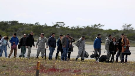 Relatives of passengers of a missing military plane arrive at an airbase in Punta Arenas, Chile on Wednesday, Dec. 11, 2019. Chile Military Plane Missing