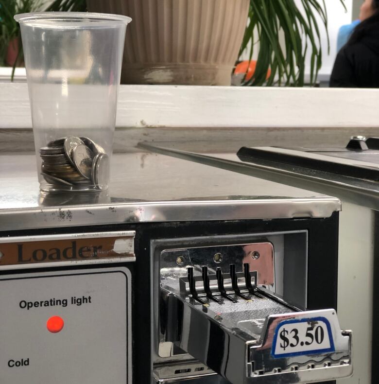 Coins are provided for patrons of the free laundry service at Family