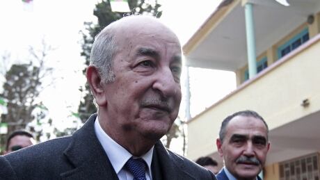 Presidential candidate Abdelmadjid Tebboune is shown Thursday on his way to casting his ballot outside a polling station, in Algiers. A former prime minister and loyalist of Algeria's influential army chief, Tebboune has been elected the country's new president in a vote boycotted by members of a vibrant nationwide protest movement. Algeria Presidential Elections