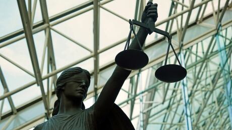The statue of Themis, Goddess of Justice resides in the atrium of the Supreme Court. Statue at B.C. Supreme Court holding scales of justice