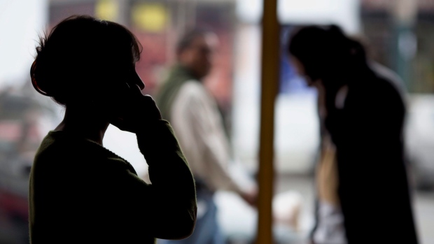 Cameron Ortis is accused of violating the Security of Information Act — what is that?; Pedestrians talk on their cellphones in Lima, Peru, on Monday, Aug\. 1, 2016\. Under a July 2015 decree, police now track cellphone locations without a court order but would need one to listen in\. All four Peruvian phone companies are cooperating\. They signed a pact with the government in Octoboer the details of which were not disclosed\.
