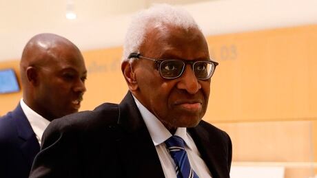 Former IAAF chief Lamine Diack arrives in a Paris court Monday for his trial in a Russia doping scandal. The 86-year-old faces a potential 10-year prison sentence for accepting millions of dollars to cover up tests showing Russian doping. diack-lamine-200113-1180