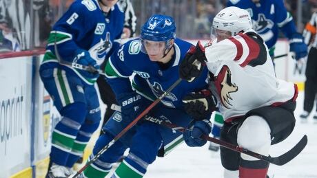Vancouver's Antoine Roussel fights for control of the puck with Arizona's Ilya Lyubushkin during the second period of the Canucks' 3-1 win over the Coyotes on Thursday. roussel-antoine-011620