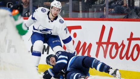 Winnipeg's Mark Scheifele gets checked by Tampa Bay's Anthony Cirelli during the second period of the Jets' 7-1 loss to the Lightning on Friday. cirelli-anthony-011720