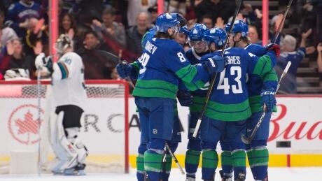 Vancouver Canucks players celebrates a goal during their 4-1 victory over the San Jose Sharks on Saturday. Sharks-Canucks-180120