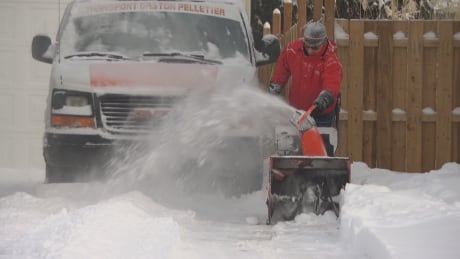 Snowblowing a driveway Jan. 19, 2020 after about 20 centimetres of snow fell on Ottawa-Gatineau. gatineau ottawa snow weather winter blower cleanup