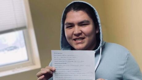 Bella Marie Poulette, 19, holds up her application to enter the pageant at the 2020 Eskasoni Winter Carnival. Bella Marie Poulette