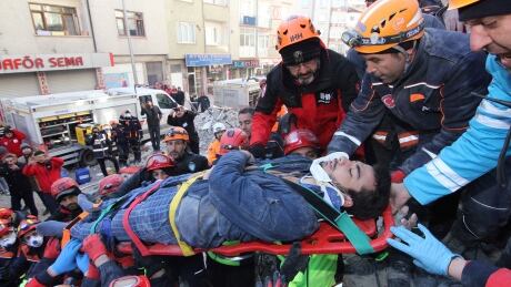 Rescue workers carry a wounded man that was found alive in the rubble of a building destroyed on Friday's earthquake in Elazig, eastern Turkey, Saturday, Jan. 25, 2020. Rescue workers were continuing to search for people buried under the rubble of apartment blocks in Elazig and neighboring Malatya. Mosques, schools, sports halls and student dormitories were opened for hundreds who left their homes after the quake. Turkey Earthquake