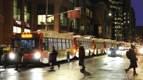 Buses queue on Albert Street in Ottawa in late January during a light rail train shortage. oc transpo special extra bus lrt o-train