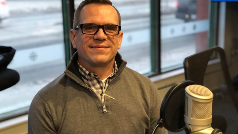 Mark Fraser sits in front of a microphone at the CBC Sudbury studios.