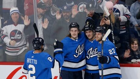 Anthony Bitetto (2), Sami Niku (8), Jack Roslovic (28) and Nikolaj Ehlers of the Jets (27) celebrate a goal. Jets-Blues-010220