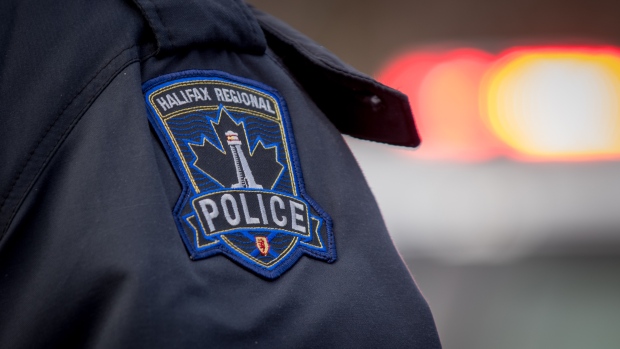 Halifax police shoot and kill 3 dogs after attack on woman in home; The badge of the Halifax Regional Police is seen on the sleeve of a navy blue shirt\.