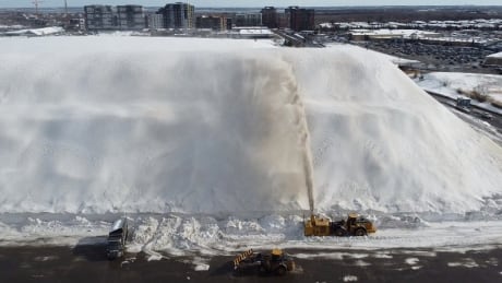 Snow cleared from Montreal's streets is piled high at this snow dump in Angrignon. snow removal giant snow pile montreal
