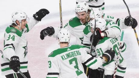 Dallas Stars forward Tyler Seguin (91) celebrates with teammates after netting the game winner against the Montreal Canadiens in Montreal on Saturday. HKN Stars Canadiens 20200215