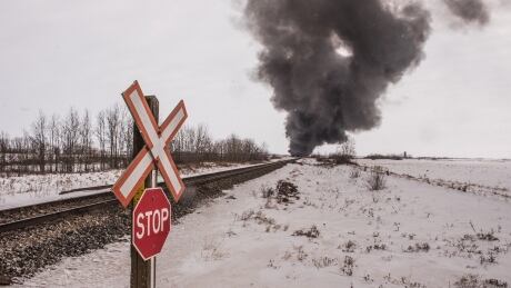 Smoke billows up from a derailed Canadian Pacific Railway train near Guernsey, Sask., on Thursday, February 6, 2020. THE CANADIAN PRESS/Matt Smith Train Derail 20200206