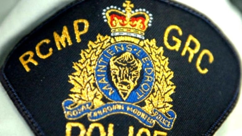 A shoulder badge says RCMP GRC over a coat of arms.