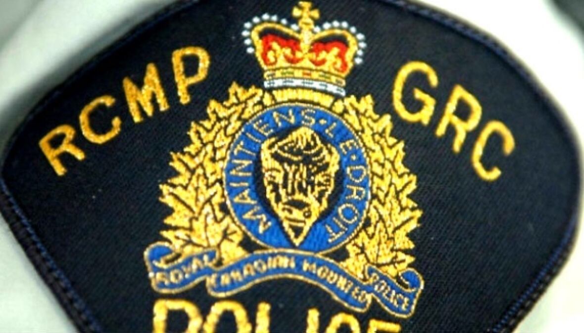 A shoulder badge says RCMP GRC over a coat of arms.