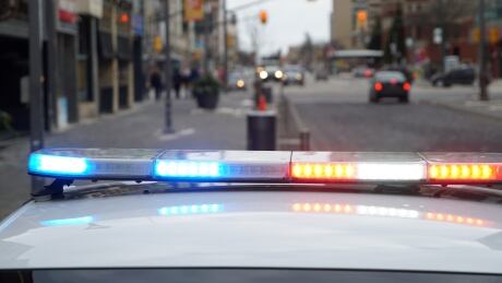 A parked London Police cruiser with its lights on in downtown London, Ontario. London Police generic