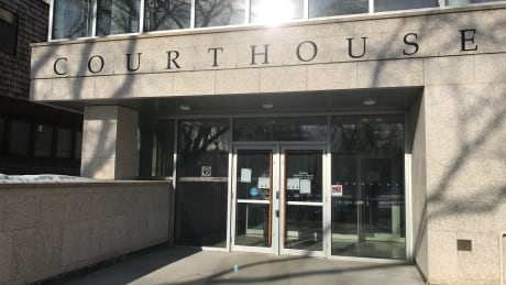 Signs on the doors at Court of Queen's Bench in Saskatoon lay out the new rules. Court