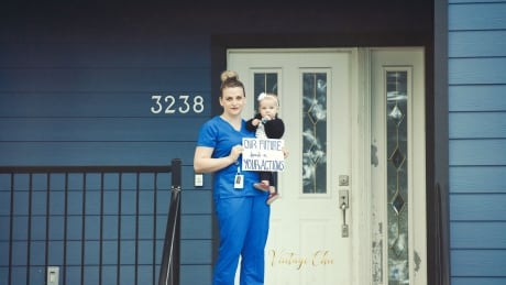 Victoria photographer Chelsea Smith is taking unique pictures of people, including this mother and daughter, on their doorsteps during this public health emergency. COVID portrait