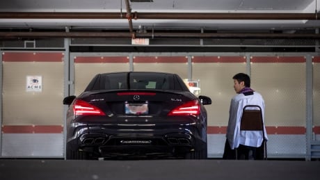 Rev. Felix Min of St. Patrick's Roman Catholic parish takes confession from a parishioner at a drive-thru confession in the churches parking lot in Vancouver, British Columbia on Wednesday, April 8, 2020. COVID-19 DRIVE-THRU CONFESSION