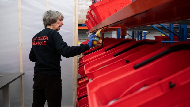 Nearly 1 in 4 Ottawa households struggled to afford food in 2023: OPH; A volunteer sorts food items after checking their expiry dates at the Ottawa Food Bank Thursday, April 23, 2020\. 