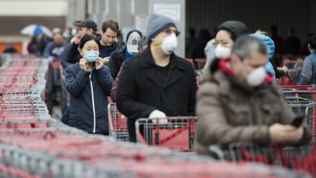 People wait in line to enter a Costco store in Toronto on Monday, April 13, 2020. Toilet paper. Flour. Gardening supplies. Over the past two months, consumers have flocked from one hot-ticket item to another, even as widespread retail closures and physical distancing measures aimed at slowing the spread of COVID-19 have Canadians spending less overall. COVID Consumer Motivations 20200507