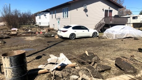 Receding flood waters in Fort Vermilion have left behind debris and silt that must be cleaned up. fort vermilion flood damage