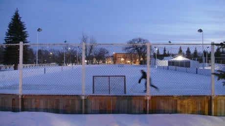 Winnipeg hotspots closing due to COVID-19. One lone person on an outdoor hockey rink at dusk, COVID-19 Winnipeg Business Closed
