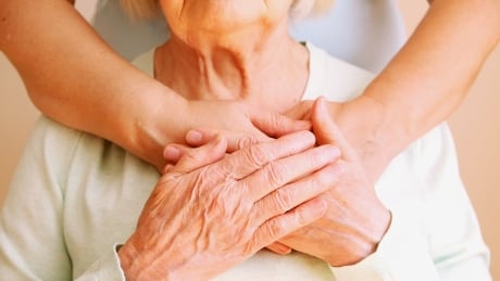 A stock image featuring a daughter hugging her elderly mother. Daughter hugs her senior mother. Care and support concept