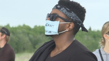 Abel Haile wears a mask reading "I can't breathe" at a Calgary protest and vigil in memory of George Floyd, a black man who was unarmed and died at the hands of white police officers. Abel Haile