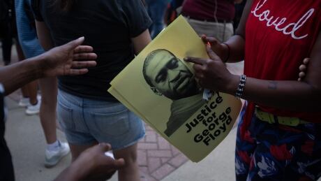 Protestors pass out photos of George Floyd at a protest to end police brutaity during a rally organized by the North Carolina NAACP in front of Charlotte - Mecklenburg Government Center in uptown Charlotte, North Carolina on June 2, 2020. - Charlotte is the designated city to hold the Republican convention from August 24 until August 27. 1217197944