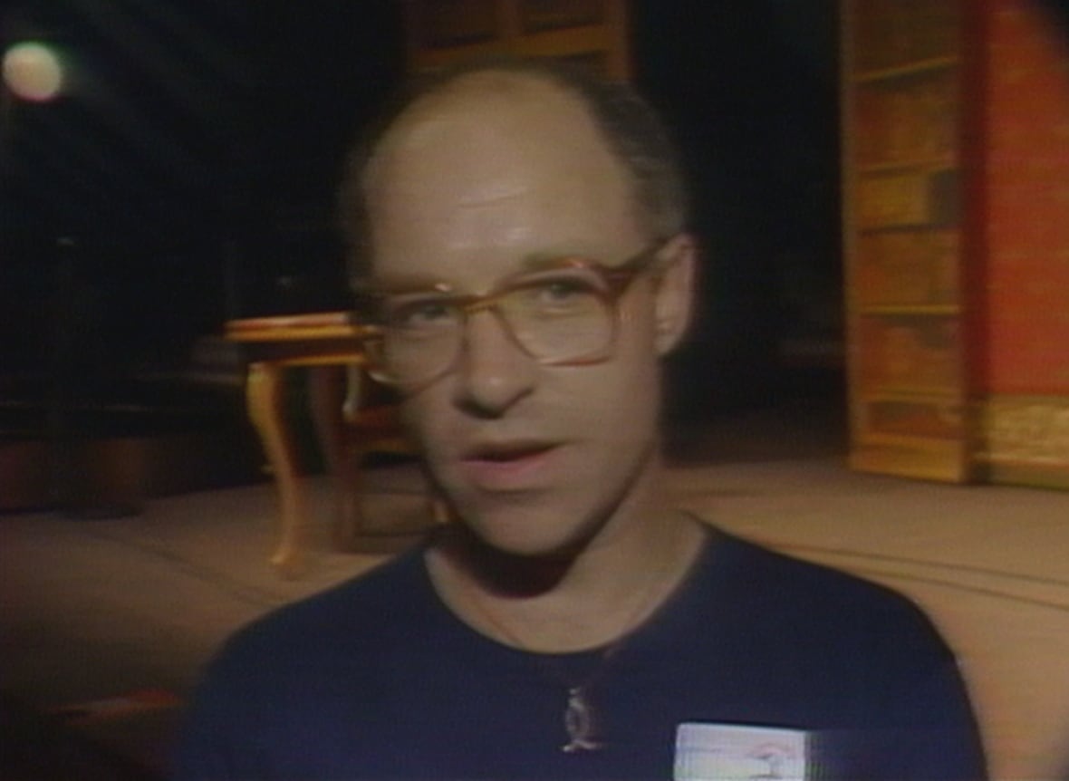 Man with glasses wearing T-shirt