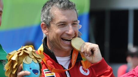 Canadian Paralympic cyclist Tristen Chernove poses with his gold medal after winning the cycling road time trial at the 2016 Summer Paralympics in Rio de Janeiro — Chernove's first Paralympic Games. chernove-07-17-20