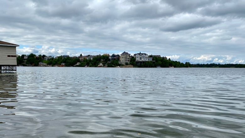A lake with some buildings on the far shore.