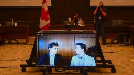 Marc Kielburger, screen left, and Craig Kielburger, screen right, appear as witnesses via videoconference during a House of Commons finance committee in the Wellington Building in Ottawa on Tuesday, July 28, 2020. The committee is looking into Government Spending, WE Charity and the Canada Student Service Grant. WE Finances 20200728